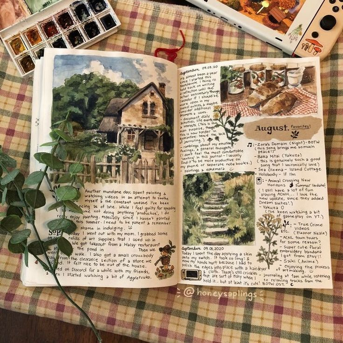 A handwritten nature journal page with watercolor paintings of a stone cottage and plants