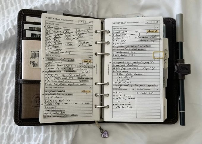 An open productivity planner with handwritten weekly entries