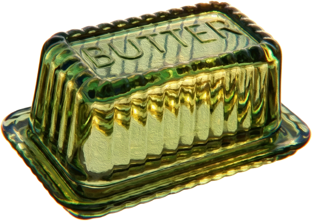 A green glass butter dish with homemade butter inside