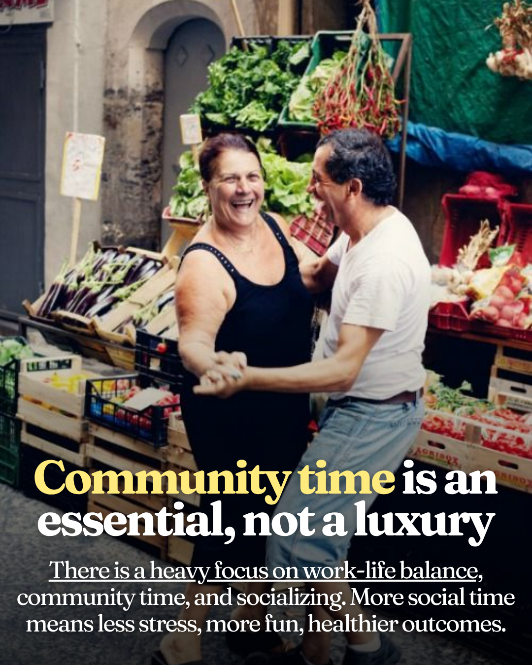 A middle-aged woman and man laughing and dancing together in front of a produce stall at a southern Italian outdoor market, surrounded by fresh vegetables